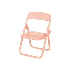 A single peach-colored miniature foldable chair is shown against a plain white background.