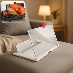 A white mobile phone screen magnifier with a red pull tab rests on a beige sofa, with an inset showing a phone displaying a