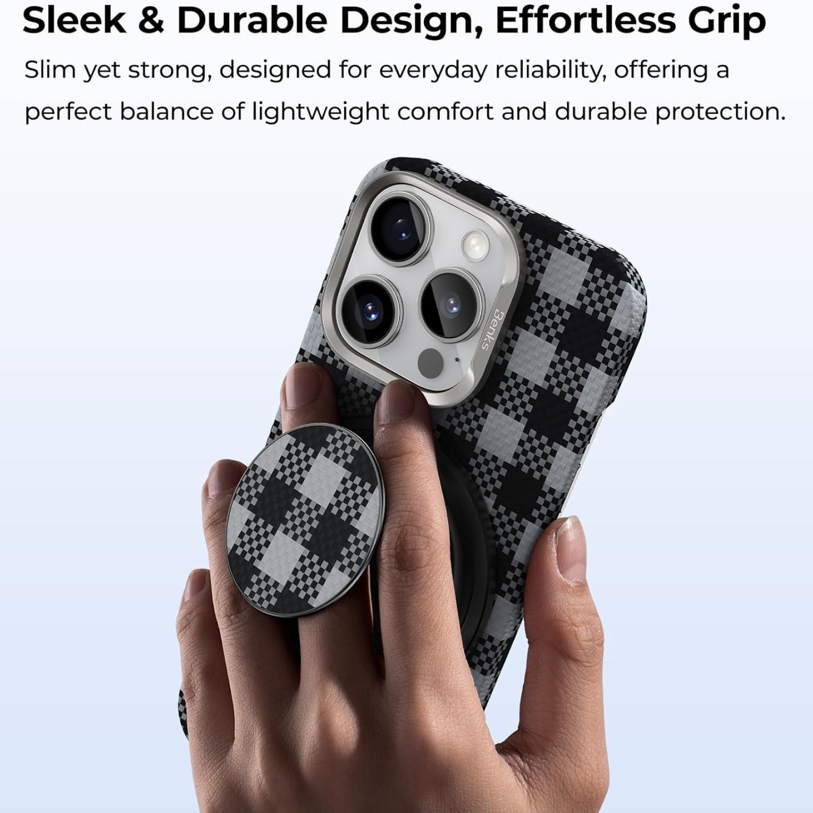 A hand holds a smartphone in a black and grey checkered case, with a matching checkered magnetic phone grip attached.