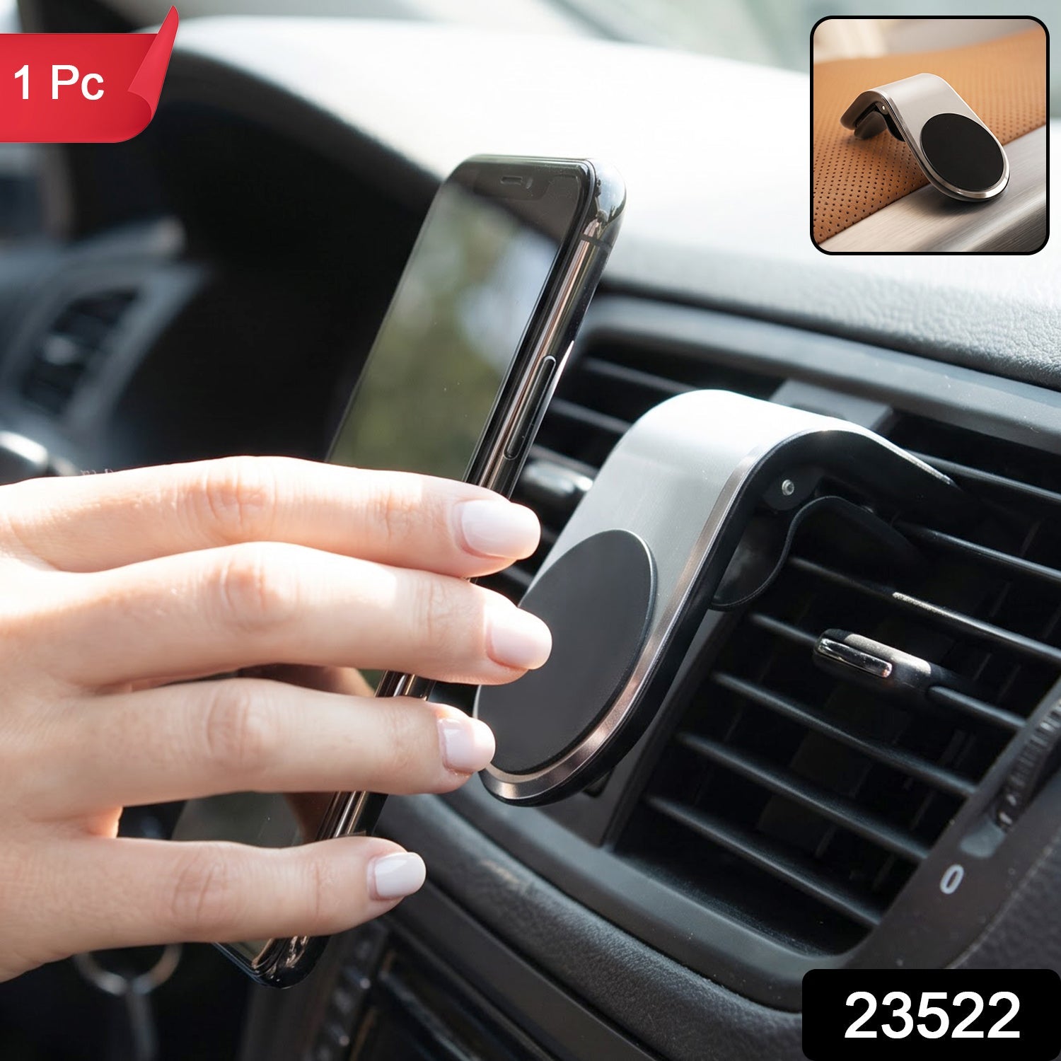 A close-up of the silver and black magnetic car phone holder on a brown textured surface.