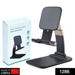 Black and gold foldable phone stand next to its white packaging box with product features listed.
