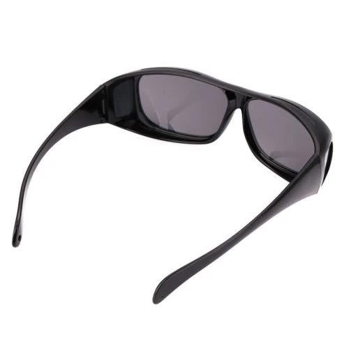 A single pair of black wrap-around glasses with dark gray lenses, viewed from the top-right, on a white background.