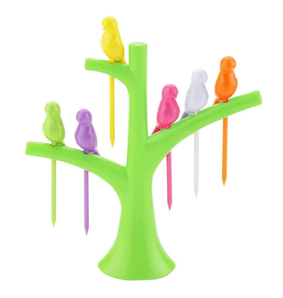 A bright green tree holder with six colorful bird fruit forks, including yellow, green, purple, pink, white, and orange.
