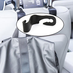Compact car back support hanger securely attached to a car seat.