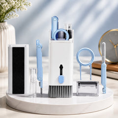 A white and light blue 7-in-1 electronic cleaning kit with various tools displayed on a white stand.