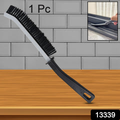 A black and gray crevice cleaning brush stands upright against a gray tiled wall, with an inset showing it cleaning a window