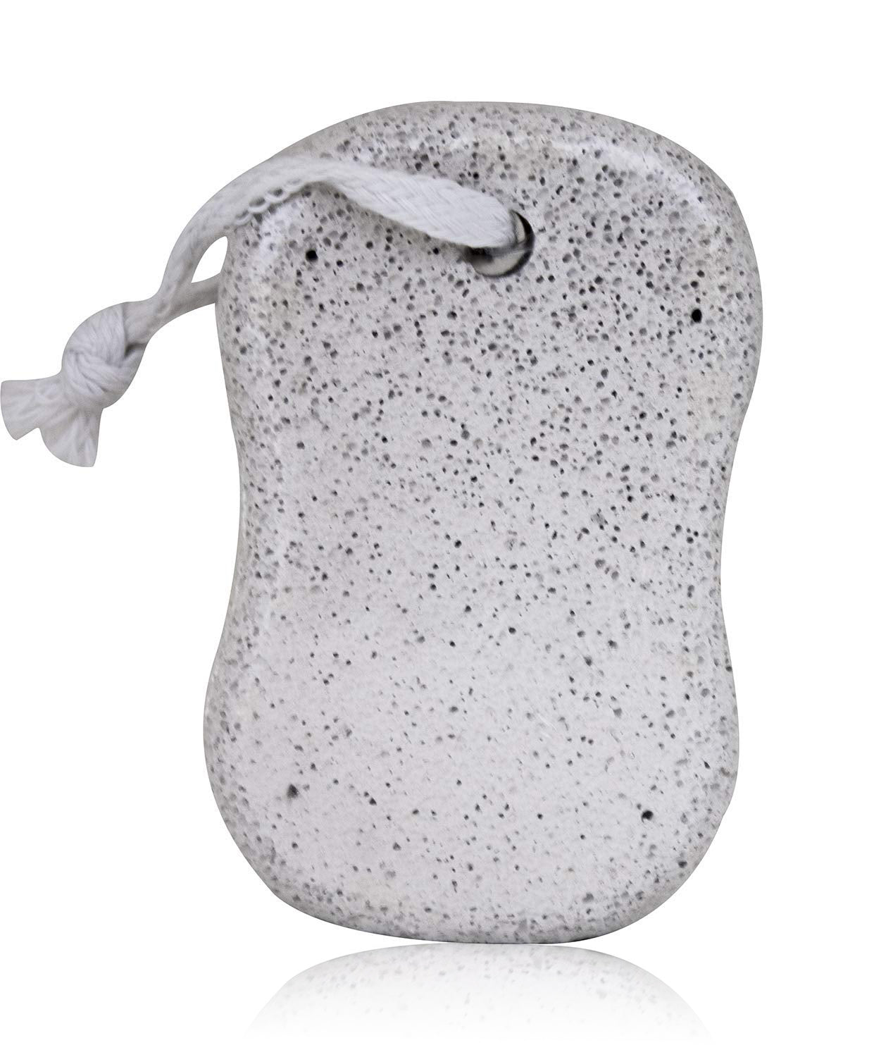 A grey, porous pumice stone with a white rope attached, casting a reflection on a white surface.