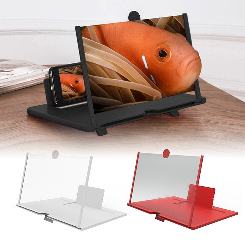 A black mobile phone screen magnifier shows a fish on its screen, with smaller white and red versions below it on a wooden