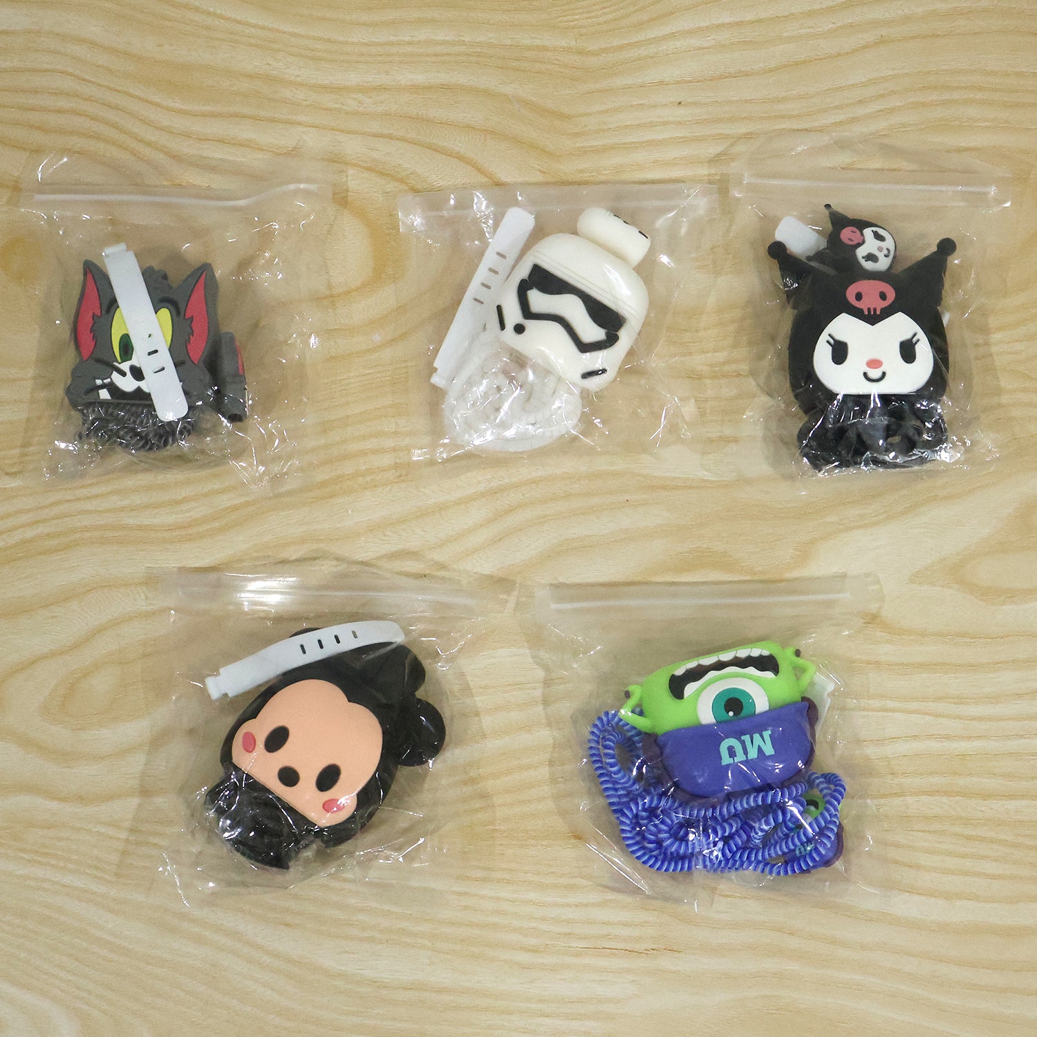 Five different cartoon character charger cover sets, each individually packaged in clear plastic bags.