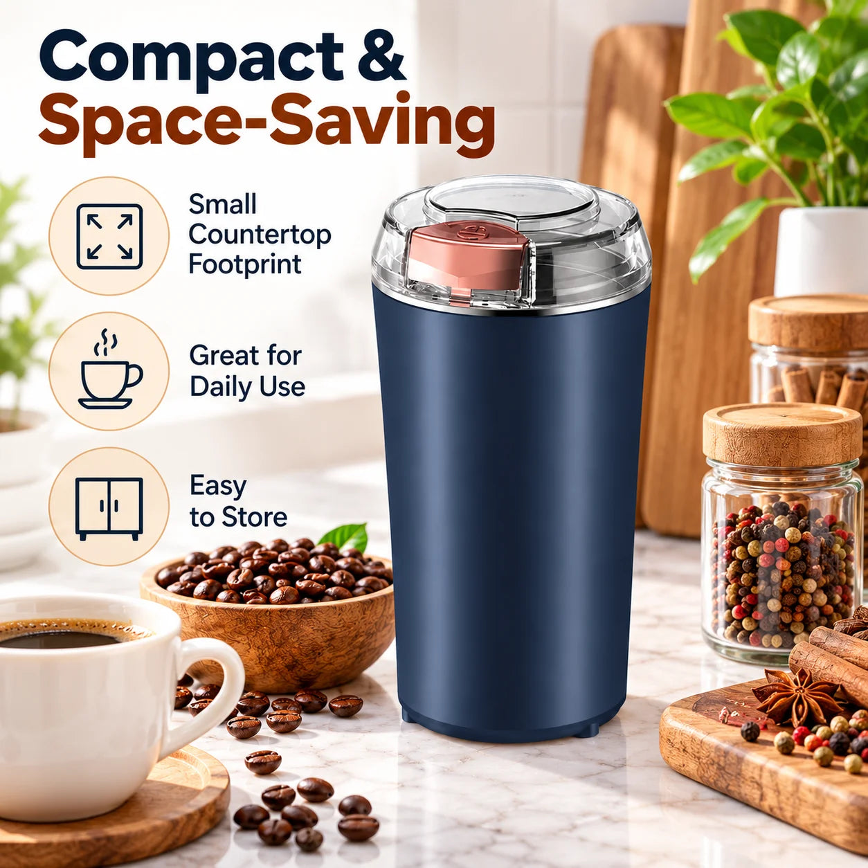 A dark blue electric grinder on a kitchen counter with coffee beans, a cup of coffee, and spice jars in the background.