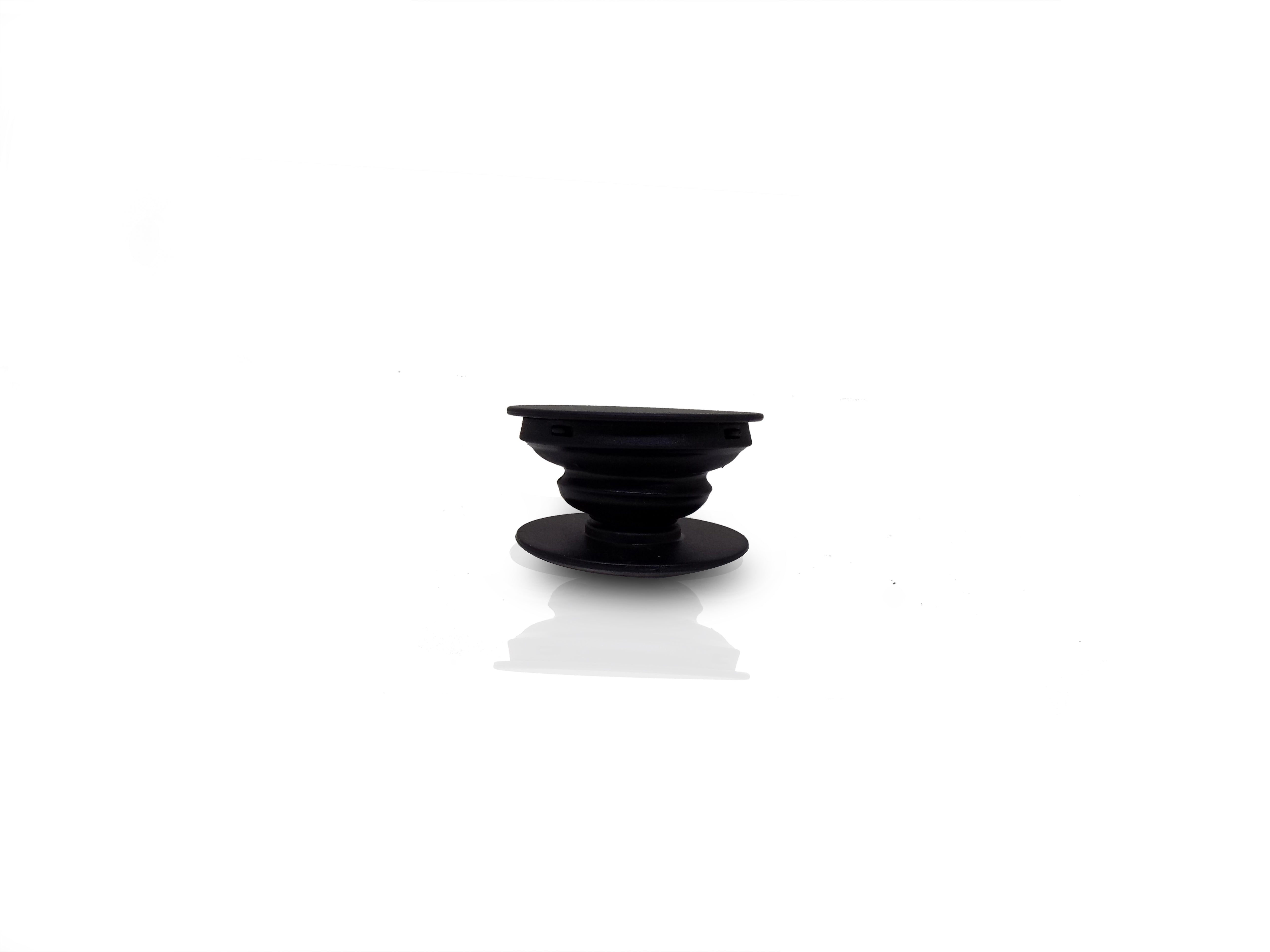 A black phone grip is shown fully expanded, showcasing its ribbed, collapsible design.