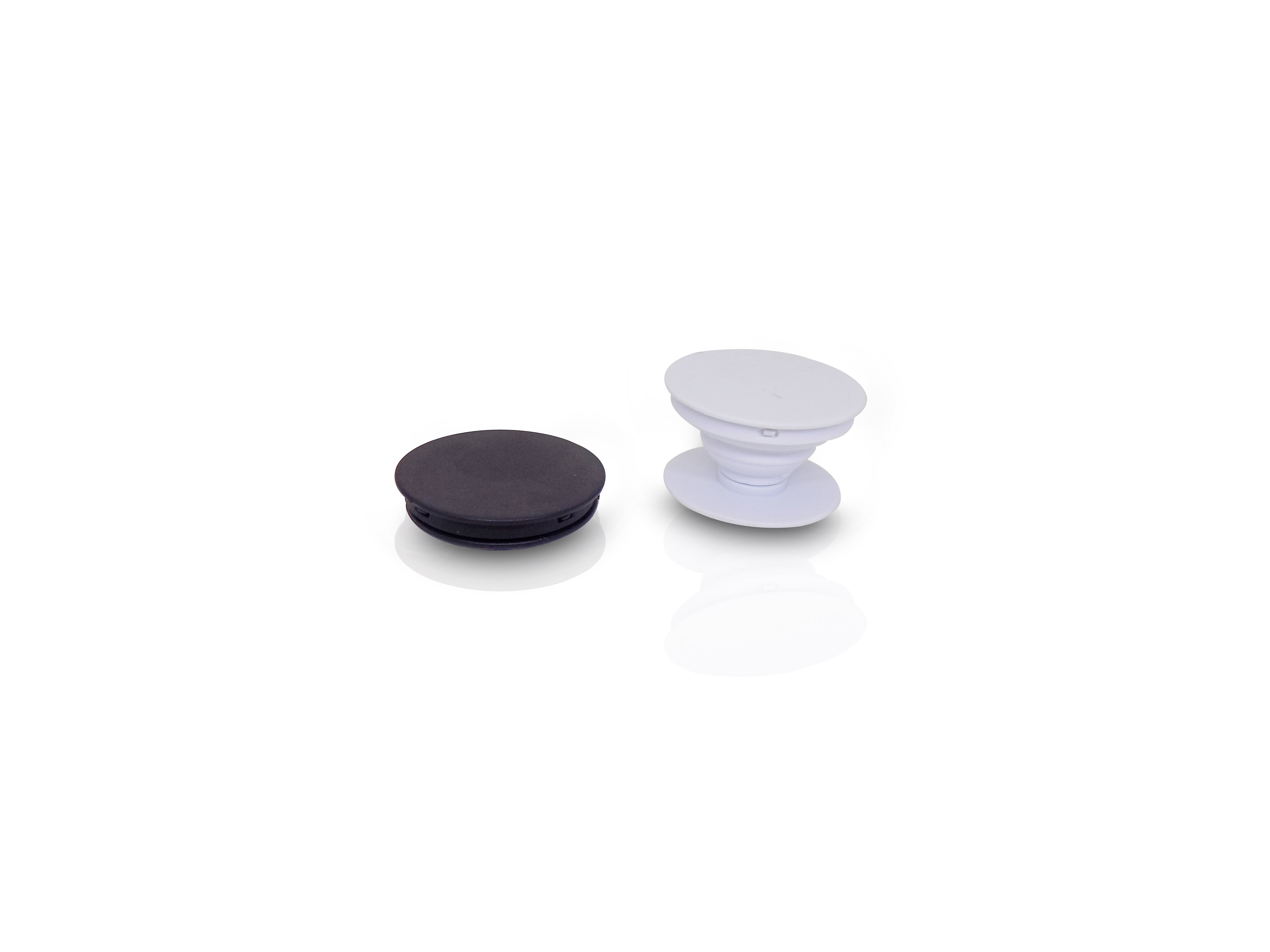 A black collapsed phone grip and an expanded white phone grip are displayed side-by-side on a white surface.