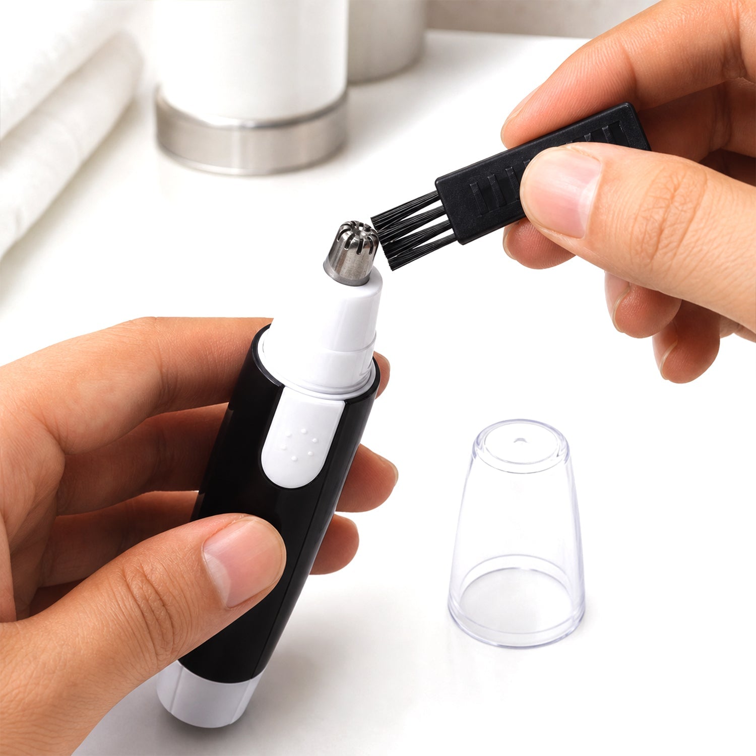 Detailed image of the black and silver nose hair trimmer showcasing its durable casing.
