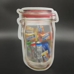 A jar-shaped zipper pouch filled with various small candies and snacks sits on a dark background.