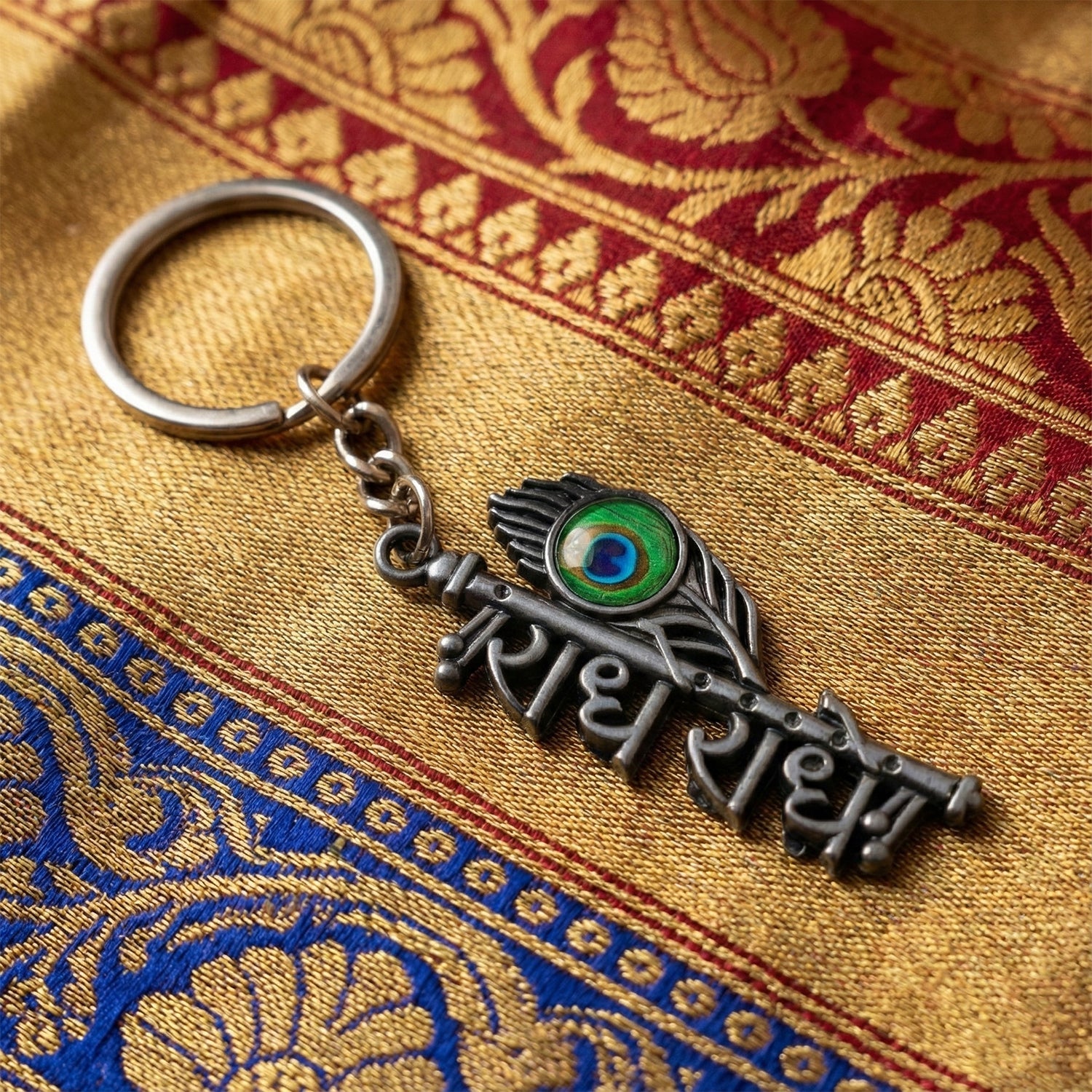 Close-up of Radhe Radhe keychain showing intricate flute and lettering details