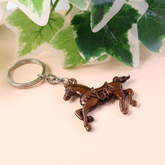 Close-up of fine engraving on horse-shaped metal keychain