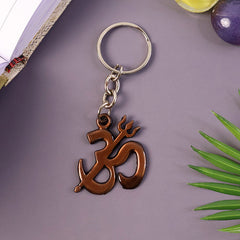 Close-up view of Om and Trishul symbols on the metal spiritual keychain