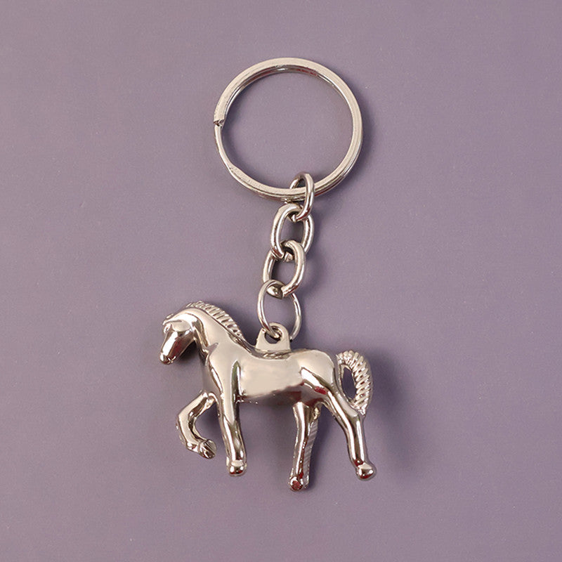 Angled view of elegant horse-shaped metallic keychain highlighting detailed craftsmanship