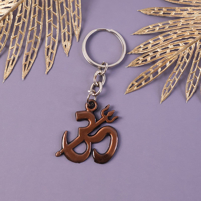 Metallic Om Trishul spiritual keychain shown on a neutral background