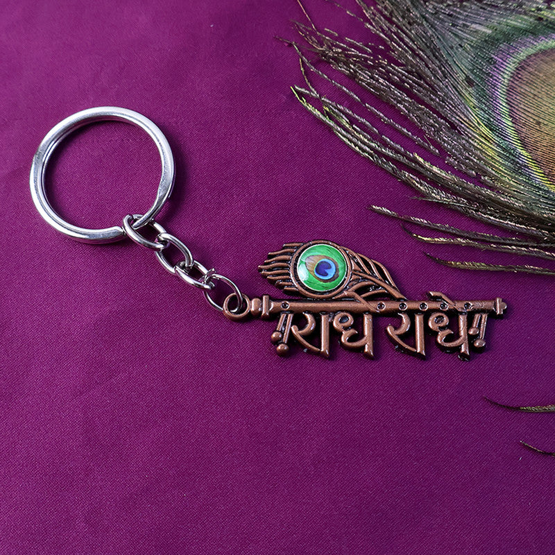 Side view of Radhe Radhe copper finish keychain highlighting detailed lettering