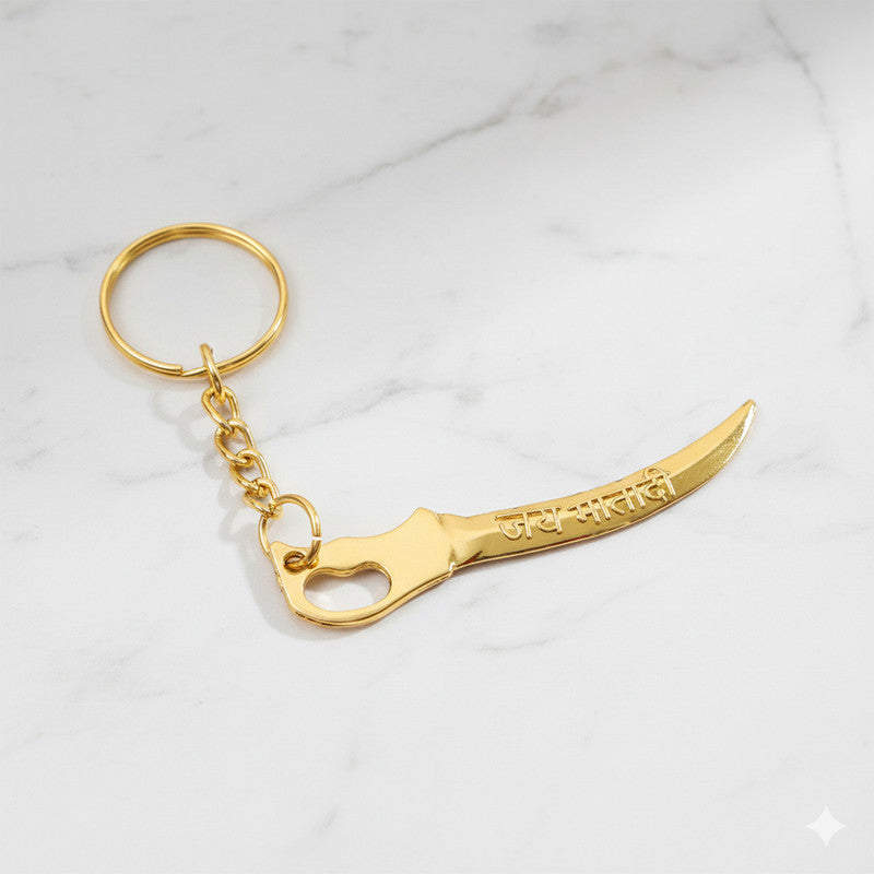 Close-up of curved sword design on golden Mataji devotional keychain