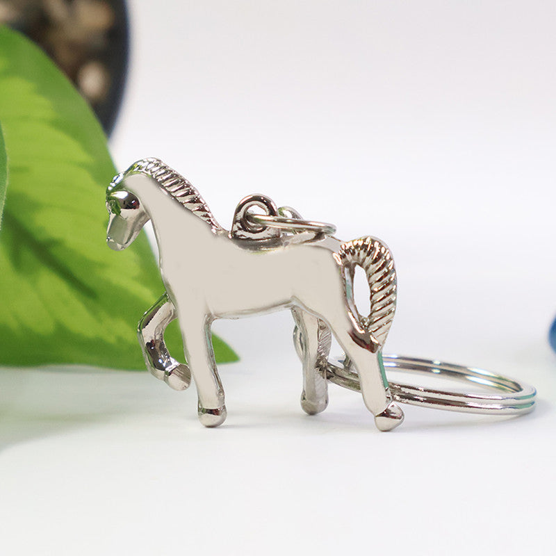 Close-up of horse figure engraving on the stylish metallic keychain