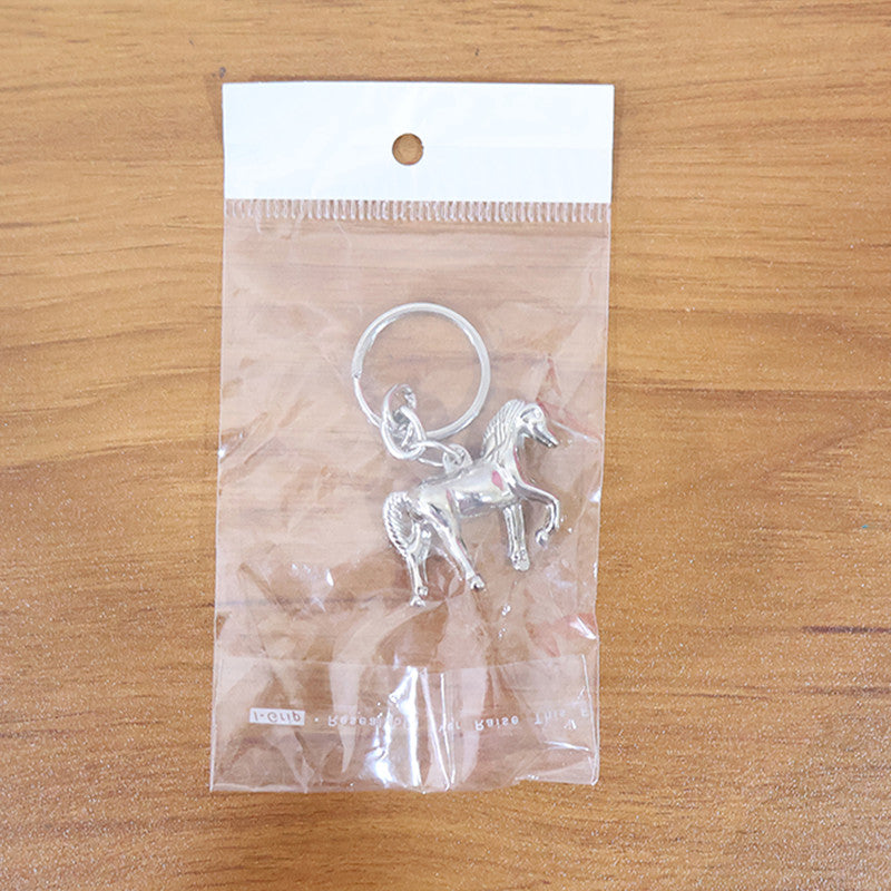 Stylish animal design keychain displayed on modern background emphasizing metallic shine