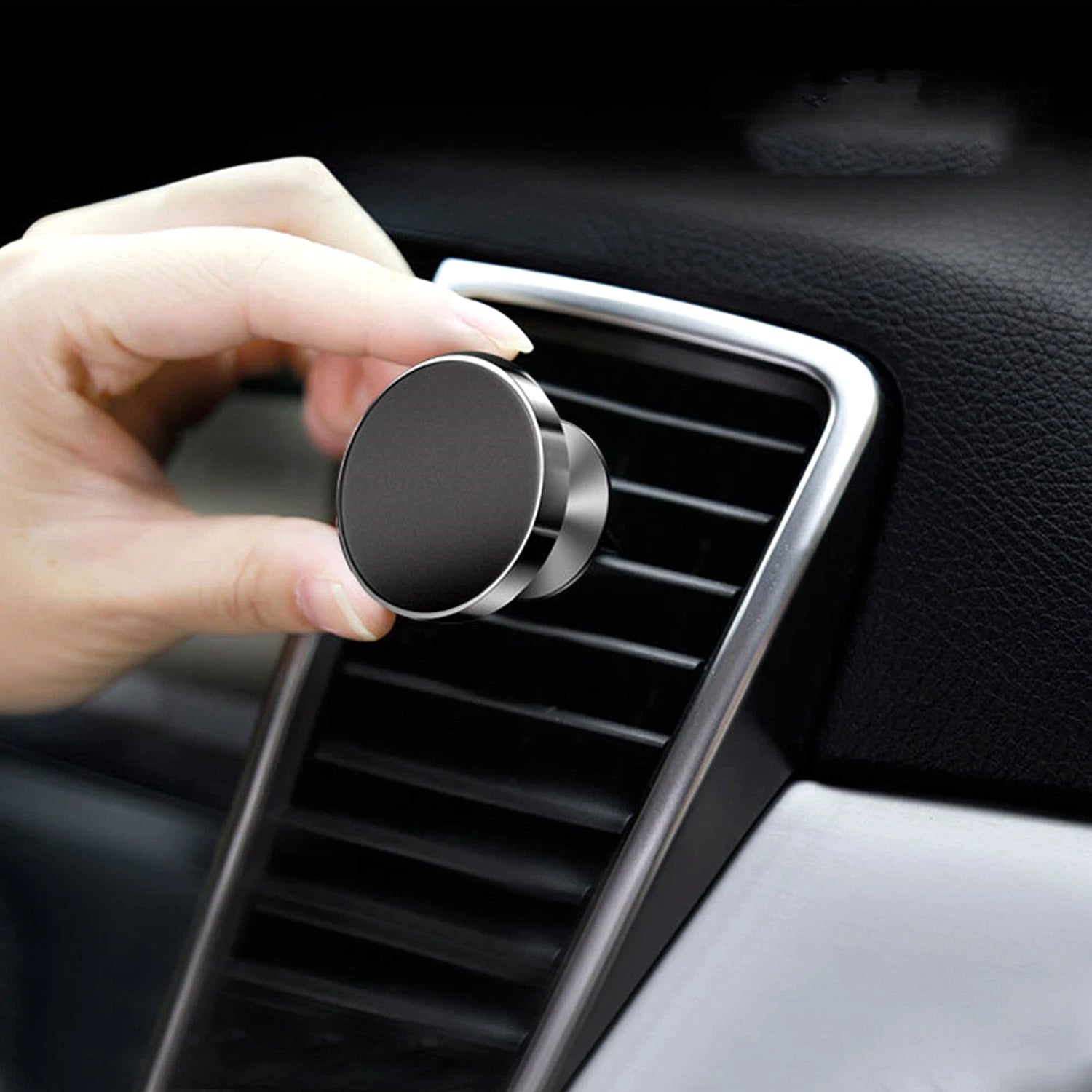 Rotating magnetic phone holder holding a smartphone inside a vehicle's air vent.