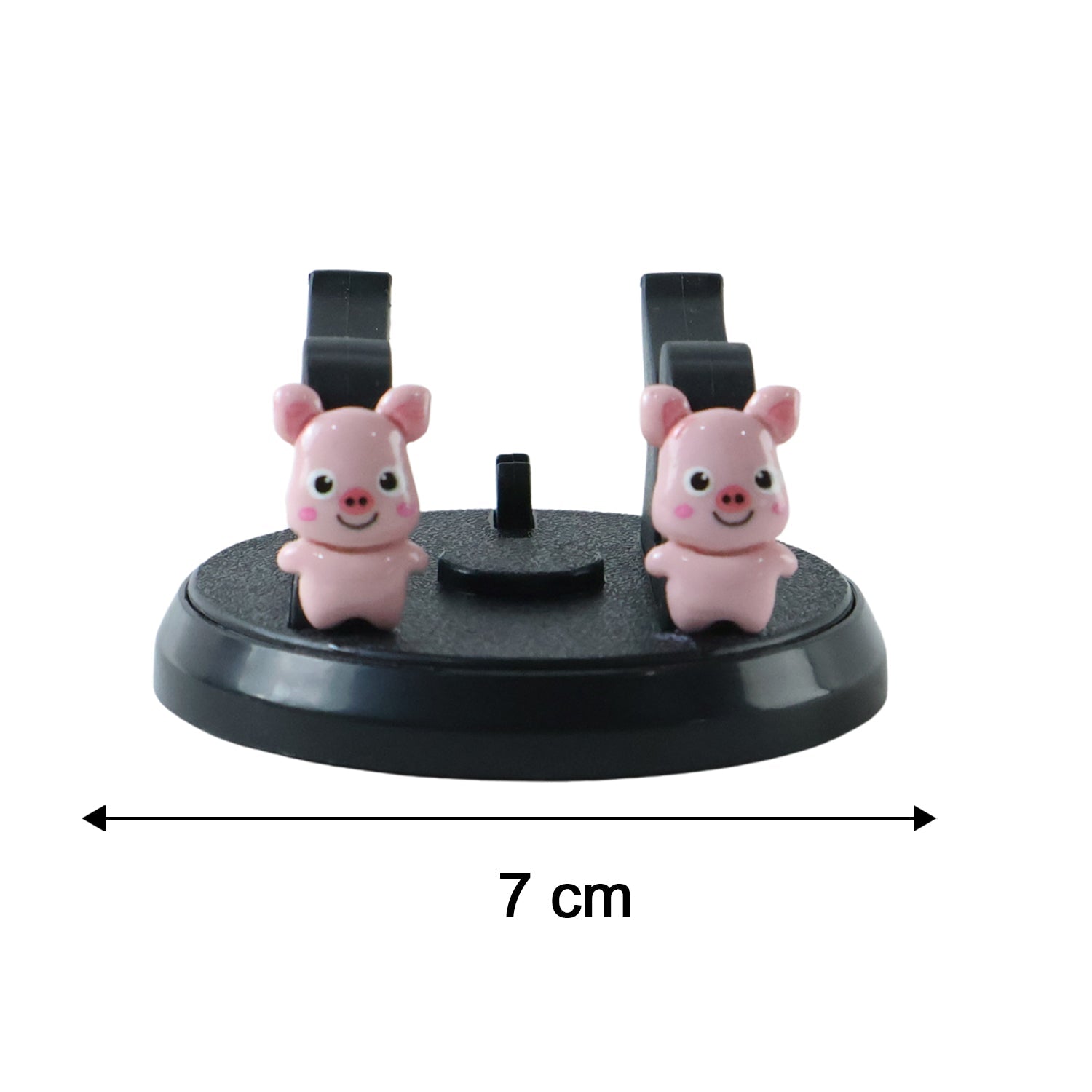 A black phone holder with two pink pig figurines, showing a 7 cm width measurement on a white background
