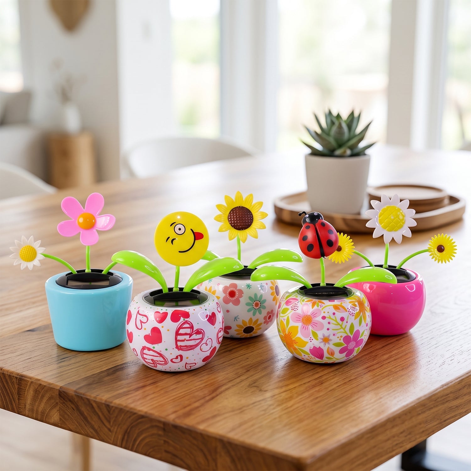 Five different solar dancing flowers in various pots, including emoji, sunflower, and ladybug designs, on a wooden table.