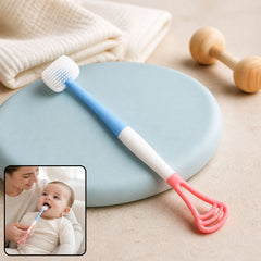 A blue, white, and pink baby tongue cleaner and toothbrush on a blue mat, with an inset of a baby using it.