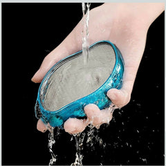 Ergonomic foot scrubber in hand for easy callus removal