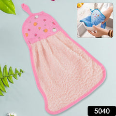 A pink microfiber hand towel with a fruit print top and hanging loop lies flat on a light blue surface next to green leaves.