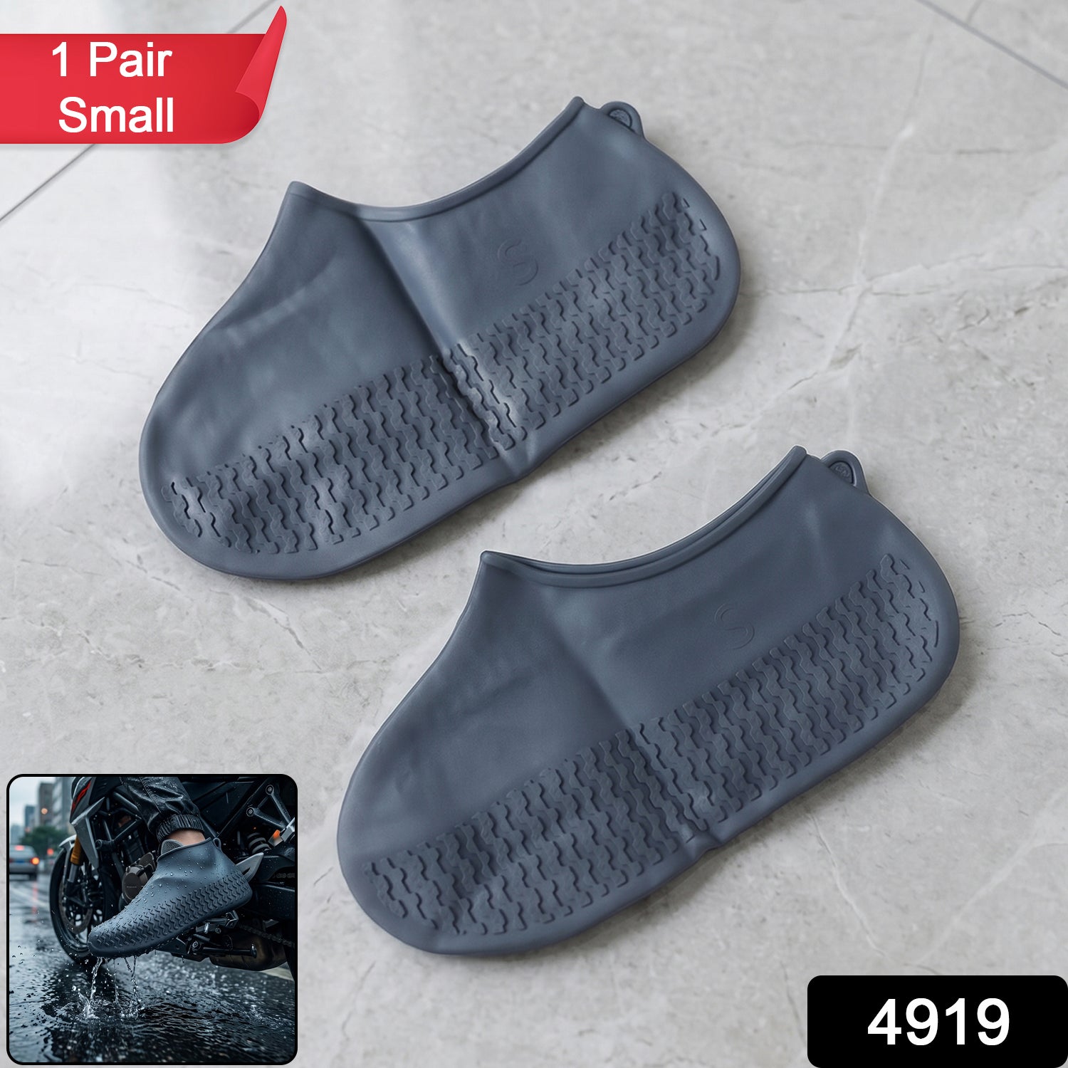 Two small grey silicone shoe covers with textured soles are displayed on a light grey tiled surface, with a small inset