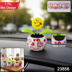 A winking emoji face flower in a heart-patterned pot on a car dashboard, with text overlays and insets.